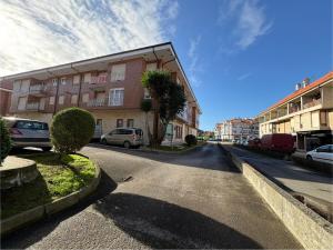 an empty street in a city with a building at Apartamento Cabo de Ajo in Ajo