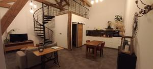 a living room with a kitchen and a spiral staircase at La Bulle Enchantée in Berru