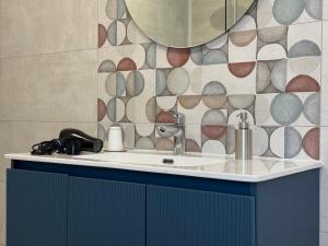 a bathroom with a sink and a mirror at OTB ITALIA - Airport Rooms in Treviso