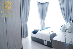 a hotel room with two beds and a window at Royal Suites 2BR - Formosa Residence in Jodoh