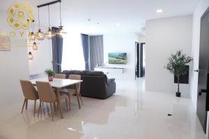 a living room with a table and a couch at Royal Suites 2BR - Formosa Residence in Jodoh