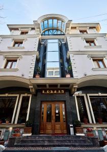 a building with a hotel sign on the front of it at Brilant Antik Center in Tirana