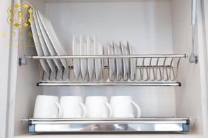 a shelf with cups and utensils in a refrigerator at Royal Suites 2BR - Formosa Residence in Jodoh +15 photos