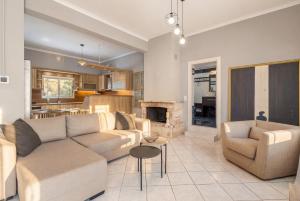 a living room with a couch and a fireplace at Martas Dream - Near Beach 2 Bedroom Deluxe Apartment in Daratso