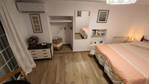 a bedroom with a bed and a dresser and a mirror at Summer Dream in Poros