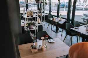 a restaurant with tables and chairs and a window at Hotel Klusenhof in Lippstadt