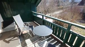 two chairs and a table on a porch at Vienna Woods Residence in Gaaden