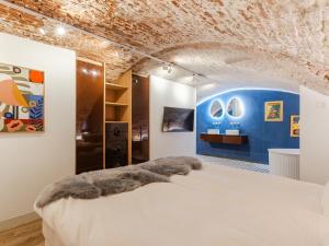 a bedroom with a bed and a blue wall at Wilsons in Utrecht