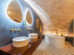 a bathroom with two sinks and a tub at Wilsons in Utrecht +23 photos