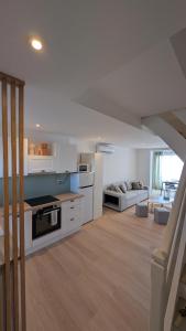 a large kitchen and living room in a house at Horizon Bleu Duplex 2 chambres vue mer in Palavas-les-Flots +13 photos