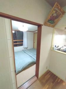 a mirror in a room with a bed in it at Mount Villa Atami in Kannami