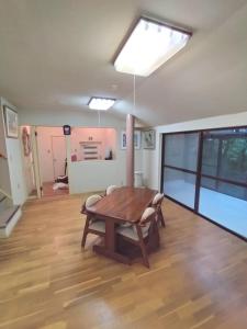 a dining room with a wooden table and a skylight at Mount Villa Atami in Kannami