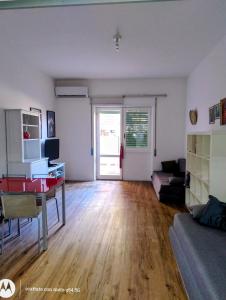 an empty living room with a table and a couch at Giordiehouse 2 Restyling in Latina