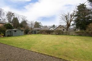 a yard with a large grassy yard with houses at OYO Ashlea Manor in Monifieth