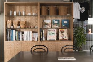 a table and chairs in front of a book shelf at At gangnam seoul in Seoul +52 photos
