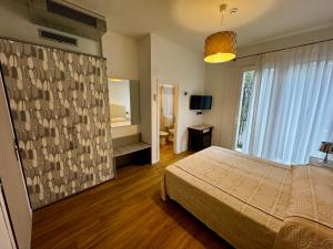 a bedroom with a bed and a large window at Hotel Blu Corallo in Marina Romea +63 photos