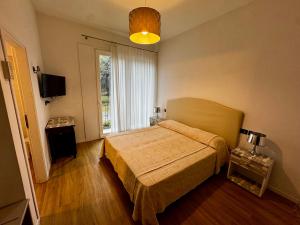 a bedroom with a bed and a large window at Hotel Blu Corallo in Marina Romea
