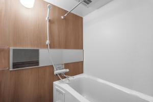 a bathroom with a toilet and a light on the wall at Gran Hills in Chitose
