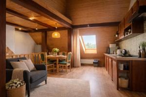 a kitchen and a living room with a couch and a table at House by the sea in Klaipėda