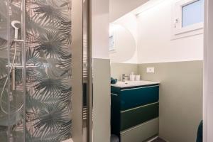 a bathroom with a shower and a sink at T'amo House in Macerata