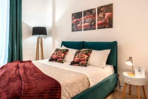a bedroom with a bed with two posters on the wall at T'amo House in Macerata