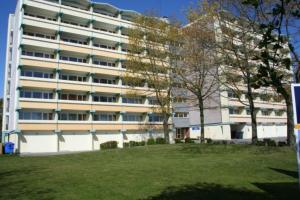 a large white building with trees in front of it at Fereinwohnung an der Ostsee E310 in Brasilien