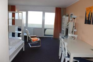 a room with a bed and a desk and a table at Fereinwohnung an der Ostsee E310 in Brasilien