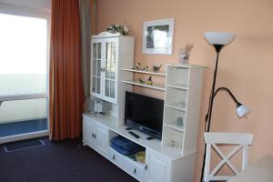 a living room with a tv and a white cabinet at Fereinwohnung an der Ostsee E310 in Brasilien