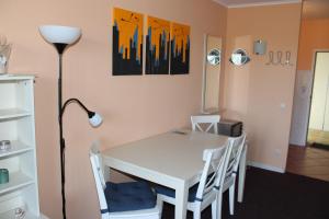 a dining room with a white table and chairs at Fereinwohnung an der Ostsee E310 in Brasilien +3 photos