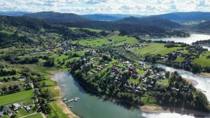 an aerial view of a town next to a river at Domek ANITA in Polańczyk