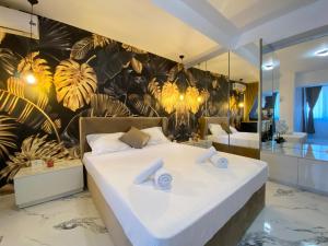 a bedroom with a large bed and a wall with plants at Mamaia-NordCom Apartamente Exclusiviste S Resort 1 CBN la plaja Azimuth in Mamaia Sat/Năvodari +188 photos