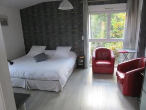 Ein Bett oder Betten in einem Zimmer der Unterkunft Au Cadran Solaire