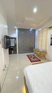 a bedroom with a bed and a tv in a room at 3Apartments in Lagos +22 photos