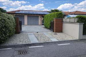 a house with a garage with a solar roof at Ca' del Maharajà in Gargallo
