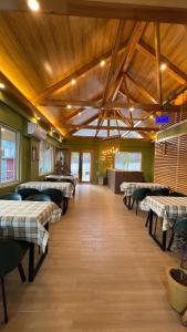 a restaurant with tables and chairs in a room at Murree Spring Apartment in Murree +172 photos