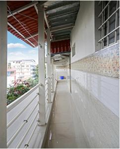 an empty hallway of a white building with aearcher at Leo Stays in Bangalore