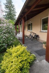 a bike parked on a porch of a house at House by the sea in Klaipėda