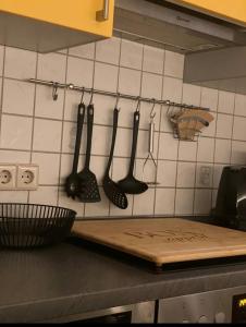 a kitchen with utensils hanging on a wall at Schöne Auszeit RE14 in Sögel
