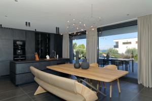 a dining room with a wooden table and chairs at Villa Sika in Vir