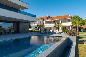 a swimming pool in the backyard of a villa at Villa Sika in Vir