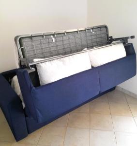 a blue bunk bed with two white pillows at Badesi Apartment - Mirto in Badesi +17 photos