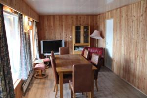 a dining room with a table and chairs and a television at Gjesvaer Fishing in Gjesvær +15 photos