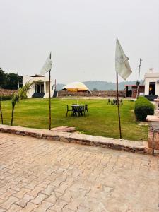 a park with a picnic table and an umbrella at Eco Fort Hotel and Resort in Mahwah