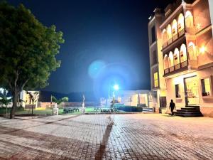 a cobblestone street in front of a building at night at Eco Fort Hotel and Resort in Mahwah