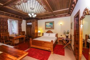 a bedroom with a bed and a table and a desk at Brilant Antik Center in Tirana