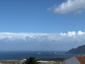 a view of the ocean with mountains in the background at Los Canteros de Belgara - Atlantic View Retreat in Frontera