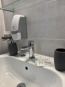 a bathroom sink with a soap dispenser on it at Rael in Cefalù +46 photos