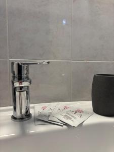 a bathroom sink with a faucet and some receipts at Rael in Cefalù