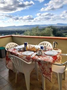 a table with plates of food on a balcony at Badesi Apartment - Mirto in Badesi
