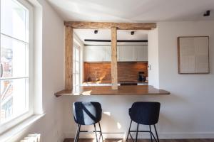 two chairs in a kitchen with a window at Boutique Charme Apartments Küferstr 10-12 in Baden-Baden